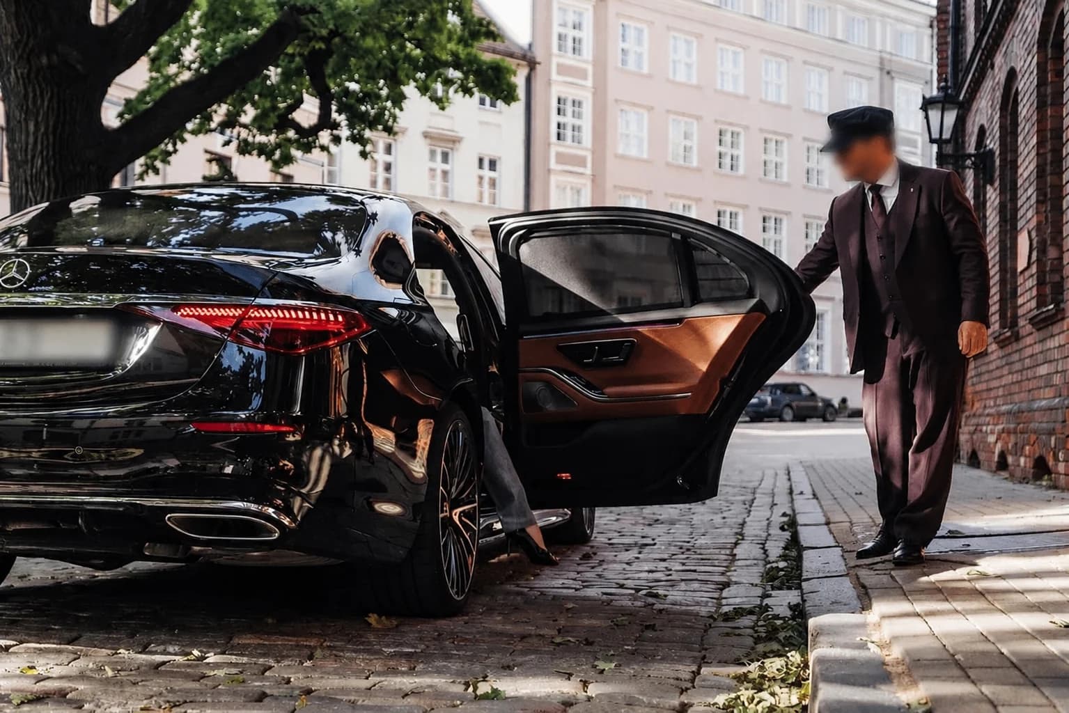 Chauffeur opening the door of a Mercedes-Benz in Stockholm